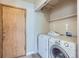 Practical laundry room with washer, dryer, and convenient shelving at 12144 Newport Dr, Brighton, CO 80602
