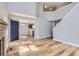 Open-concept living space with hardwood floors, connecting the living room, dining area, and kitchen at 12144 Newport Dr, Brighton, CO 80602