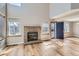 Bright and airy living room with a brick fireplace, large windows, and an open layout at 12144 Newport Dr, Brighton, CO 80602