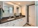 Bathroom with double sink vanity, quartz countertop, and large mirror at 1145 S Logan St, Denver, CO 80210