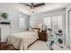 Bright bedroom with ceiling fan, comfortable bed, and natural light from two windows at 1145 S Logan St, Denver, CO 80210