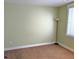 Neutral-toned bedroom with plush carpeting, lots of natural light from a window, and a modern floor lamp at 1145 S Logan St, Denver, CO 80210