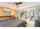 Inviting bedroom with gray walls, ceiling fan, adjacent stairs and windows providing lots of light at 1145 S Logan St, Denver, CO 80210