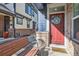 Inviting front porch with red door and decor at 1145 S Logan St, Denver, CO 80210
