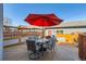 Outdoor dining area on wood deck with seating under red umbrella at 1145 S Logan St, Denver, CO 80210