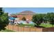 Community pool area with a waterslide, splash pad, lounge chairs, and ample green space for relaxation at 9606 Whitecliff Pl, Highlands Ranch, CO 80129