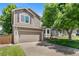 Charming two-story home with a two car garage, tidy landscaping, and a well-manicured front lawn at 9606 Whitecliff Pl, Highlands Ranch, CO 80129