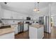 Well-lit kitchen with stainless steel appliances, granite countertops, and white cabinetry at 9606 Whitecliff Pl, Highlands Ranch, CO 80129