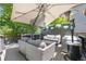 Outdoor living area on deck, featuring patio furniture, overhead umbrella, heater, and privacy screen at 9606 Whitecliff Pl, Highlands Ranch, CO 80129