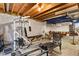 Spacious basement with workout area featuring a pool table and exposed wood ceiling beams at 13235 Clermont Cir, Thornton, CO 80241