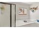Modern bathroom featuring a soaking tub with tile surround and a separate glass-enclosed shower at 13235 Clermont Cir, Thornton, CO 80241