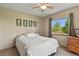 Bedroom featuring a ceiling fan, neutral walls, a window with natural light, and a dresser at 13235 Clermont Cir, Thornton, CO 80241