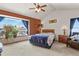 Bedroom with a vaulted ceiling, large window, and patterned bedding at 13235 Clermont Cir, Thornton, CO 80241
