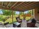 Relaxing covered patio with comfortable seating overlooking a well-manicured backyard at 13235 Clermont Cir, Thornton, CO 80241