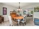 Dining room with hardwood table, upholstered chairs, and chandelier lighting at 13235 Clermont Cir, Thornton, CO 80241