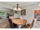 Dining room featuring a wooden table with plush chairs and a modern chandelier at 13235 Clermont Cir, Thornton, CO 80241