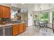 Bright eat-in kitchen with wood cabinets, modern appliances, and a view of the backyard at 13235 Clermont Cir, Thornton, CO 80241
