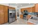 Bright kitchen featuring stainless steel appliances, wood cabinets, and a mosaic backsplash at 13235 Clermont Cir, Thornton, CO 80241