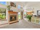 Living room with fireplace, sunny windows, and seamless flow to the outdoor space at 13235 Clermont Cir, Thornton, CO 80241
