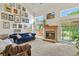 Bright living room features fireplace, picture windows and access to the backyard at 13235 Clermont Cir, Thornton, CO 80241