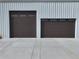 Garage doors with classic paneled design and ample concrete driveway space at 14550 Arfsten Rd, Larkspur, CO 80118