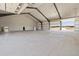Large open interior featuring overhead doors and ample natural light from the exterior at 14550 Arfsten Rd, Larkspur, CO 80118