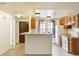 Bright kitchen with white appliances, wooden cabinets, and a convenient breakfast bar at 1545 S Ouray Cir # B, Aurora, CO 80017