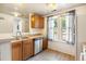 Functional kitchen with stainless steel appliances, wood cabinets, and plenty of natural light at 1545 S Ouray Cir # B, Aurora, CO 80017