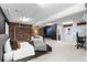 Well-lit basement bedroom with brick accent wall, comfortable furnishings and modern decor at 2560 Blake # 101, Denver, CO 80205