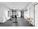 A basement gym with an assortment of exercise equipment, mirrors, and rubber flooring at 2560 Blake # 101, Denver, CO 80205