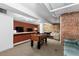 Basement recreation area with a foosball table, exposed brick, and bar area at 2560 Blake # 101, Denver, CO 80205