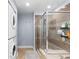 Bathroom featuring shower and washer/dryer set with a tiled floor, glass shower, and modern appliances at 2560 Blake # 101, Denver, CO 80205