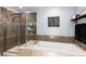 Bathroom featuring a separate shower and bathtub combination, tiled walls, and modern fixtures at 2560 Blake # 101, Denver, CO 80205