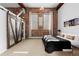 Inviting bedroom featuring exposed brick, a comfortable bed, stylish nightstands, and industrial sliding door at 2560 Blake # 101, Denver, CO 80205