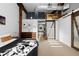 Bright bedroom with a view to a kitchen and dining area, wooden beams, and an industrial style duct at 2560 Blake # 101, Denver, CO 80205