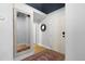 Clean entryway featuring hardwood floors, a decorative mirror, and ample lighting at 2560 Blake # 101, Denver, CO 80205