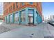 Exterior view of a brick building with large windows and blue trim, showcasing its architectural style at 2560 Blake # 101, Denver, CO 80205