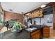 Kitchen with dark granite countertops, wooden cabinets, and open living space with a spiral staircase to a loft at 2560 Blake # 101, Denver, CO 80205