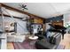 Open-concept living room with spiral staircase, exposed wooden beams, piano, and comfortable seating at 2560 Blake # 101, Denver, CO 80205