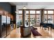 Spacious kitchen/living room combo with hardwood floors, stainless appliances, and a piano at 2560 Blake # 101, Denver, CO 80205