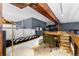 Cozy loft area with a daybed, desk, and exposed wooden beams, creating a unique workspace at 2560 Blake # 101, Denver, CO 80205