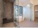 Spa bathroom with a glass enclosed shower and free standing tub under a picture window at 27 Boulder Cir, Breckenridge, CO 80424