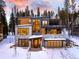 Modern two-story home featuring a stone and wood facade, balcony, and a snow-covered driveway at 27 Boulder Cir, Breckenridge, CO 80424