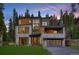 Striking modern home featuring stone accents, wood panels, an upper deck, and a spacious two-car garage at 27 Boulder Cir, Breckenridge, CO 80424