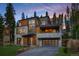Striking modern home boasts a stone facade, expansive windows, and multi-level decks nestled in a wooded setting at 27 Boulder Cir, Breckenridge, CO 80424