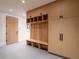 Well-organized mud room with custom wood cabinetry, built-in bench, and ample storage, designed for functionality at 27 Boulder Cir, Breckenridge, CO 80424