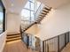A bright, open staircase features modern design with wood treads, iron railings, and expansive windows for natural light at 27 Boulder Cir, Breckenridge, CO 80424