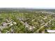 Expansive aerial view of a community nestled among lush greenery and rolling hills, near a golf course and the mountains in the distance at 701 Harlan St # E53, Lakewood, CO 80214