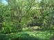 Lush backyard oasis featuring mature trees and a flowing creek at 701 Harlan St # E53, Lakewood, CO 80214