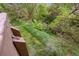 Tranquil greenery surrounds this home, as seen from the back balcony in a wooded setting at 701 Harlan St # E53, Lakewood, CO 80214